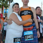 Two individuals in creative costumes and body paint at a festive event