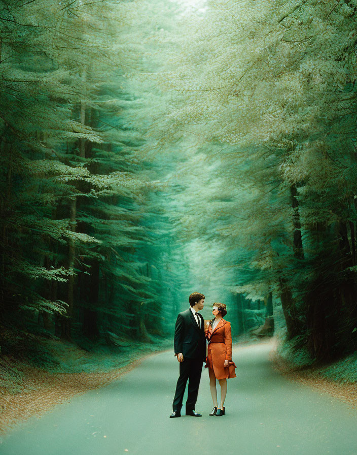 Man and woman in surreal forested landscape with glowing teal trees