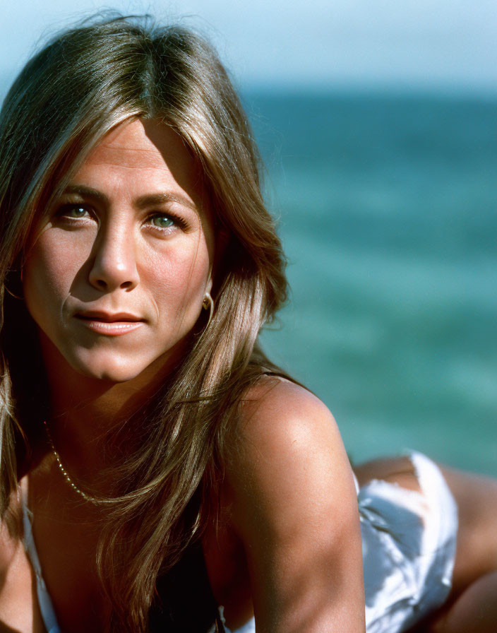 Woman with Sun-Kissed Hair in White Outfit by the Ocean