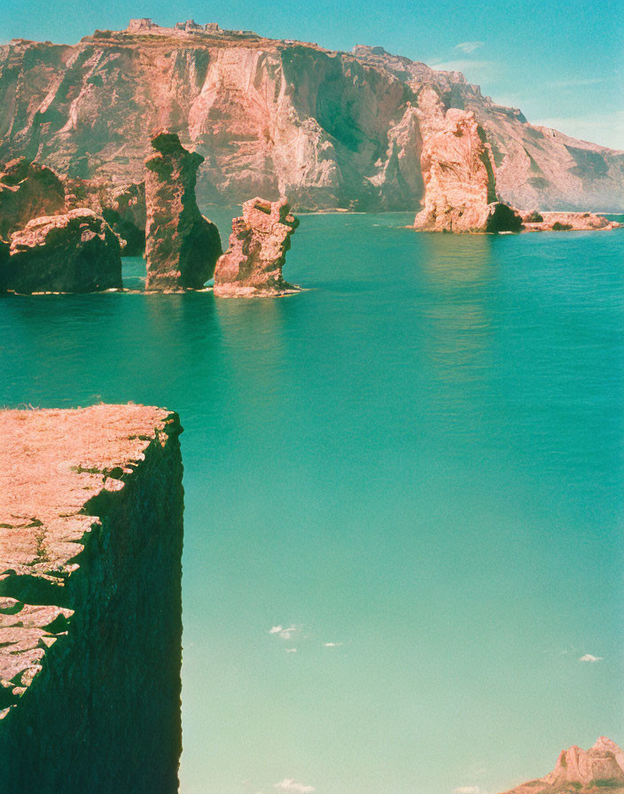 Turquoise Waters and Coastal Cliffs Against Blue Sky