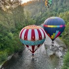 Vibrant hot air balloons over textured mosaic landscape