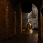 Fantastical castle hallway with golden staircases and glowing lanterns