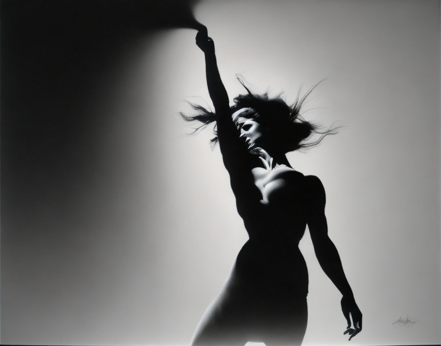 Monochrome image of woman in dynamic pose with flowing hair