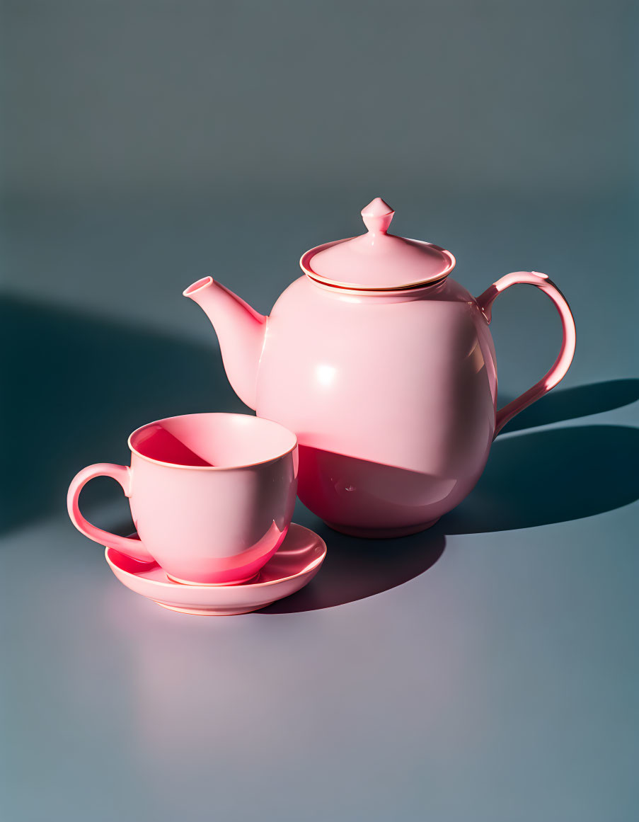 Pink Teapot, Cup, and Saucer on Grey Surface with Shadow Detail