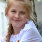 Blonde woman with red flower braids in lilac outfit