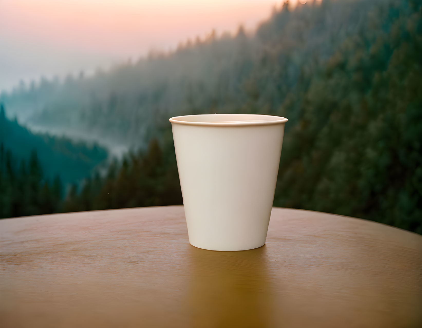 White Cup on Wooden Surface with Mountain Landscape in Soft Light