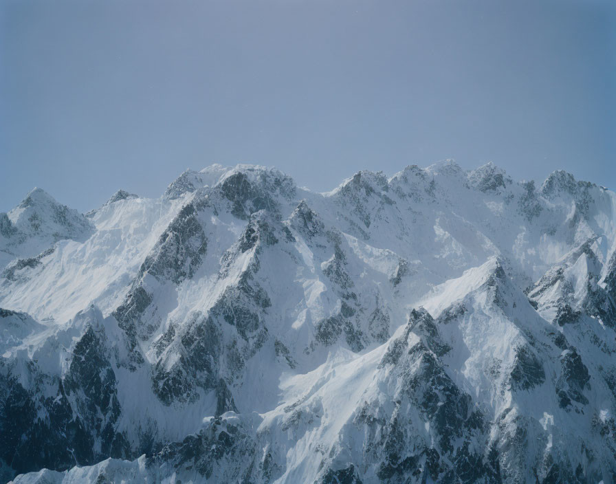 Majestic snow-capped mountain peaks under blue sky