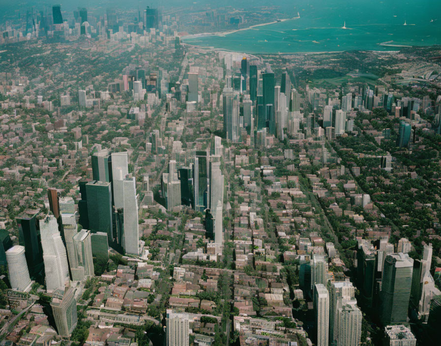 Dense Urban Skyline with Skyscrapers, Green Spaces, and Waterfront