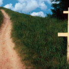 Cobblestone Pathway with Wooden Cross on Hilltop