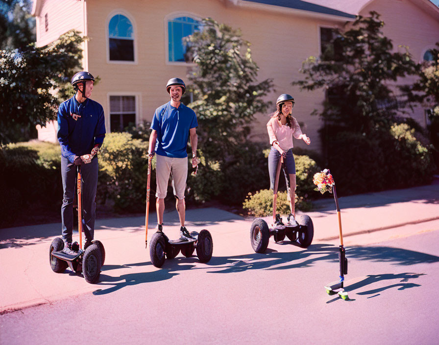 Three People Riding Electric Segways on Sunny Residential Street