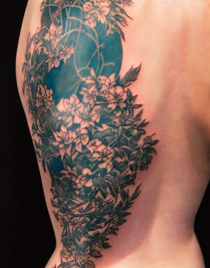 Detailed Monochromatic Floral Arm Tattoo with Leaves and Blossoms