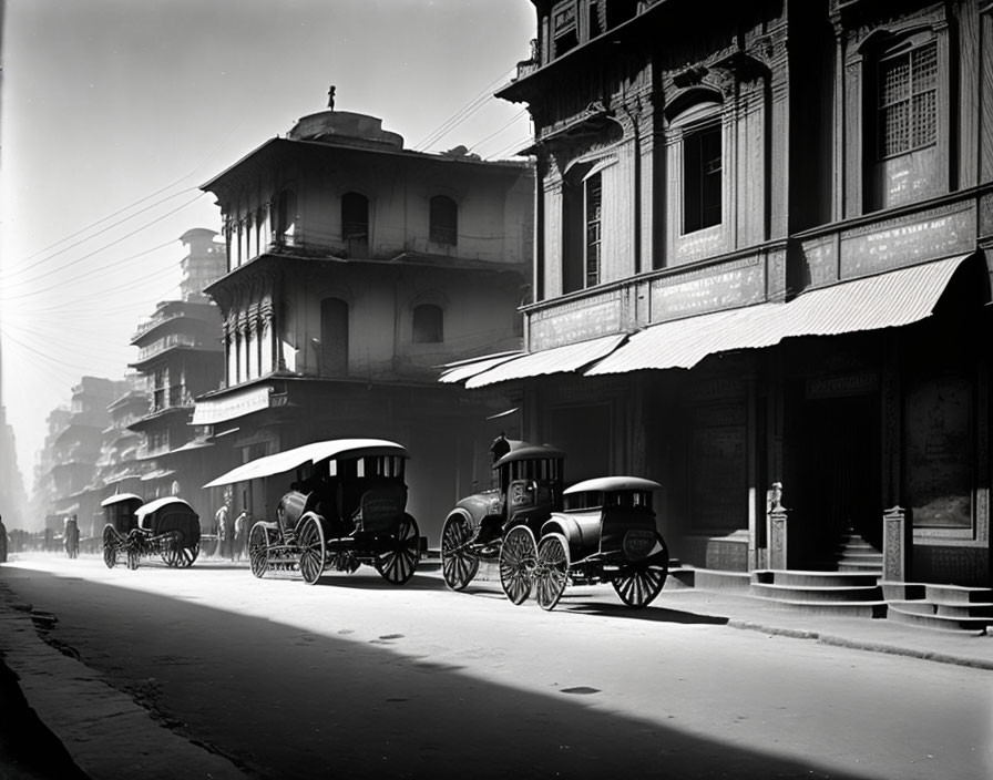 Monochrome photo of vintage street with horse-drawn carriages