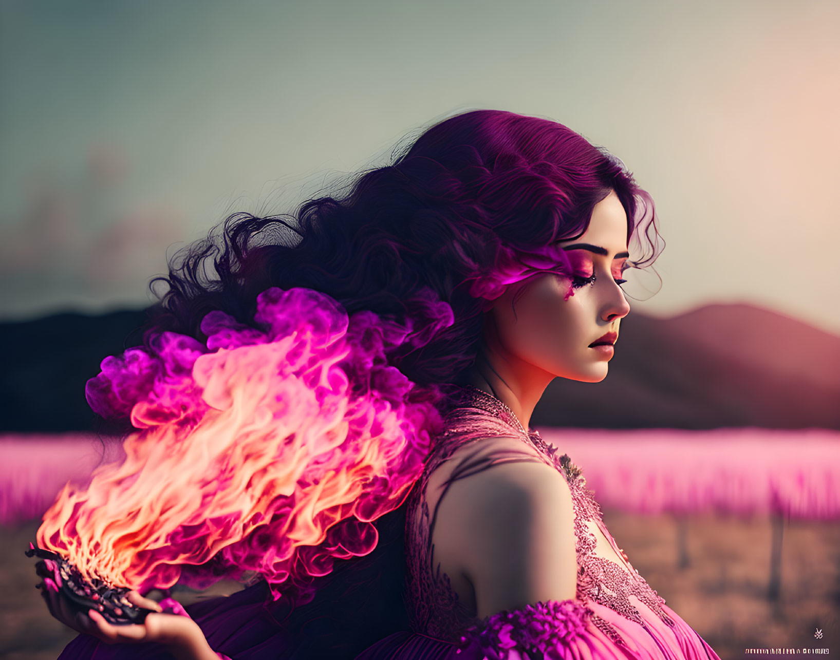 Woman in violet dress holds fire with purple smoke in dusky landscape