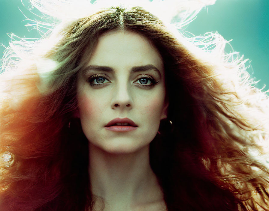 Woman with Voluminous Red Wavy Hair and Striking Blue Eyes Portrait