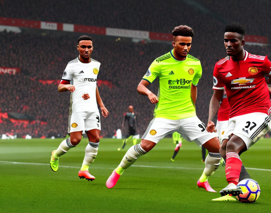 Soccer players in Manchester United and green/yellow kits on pitch