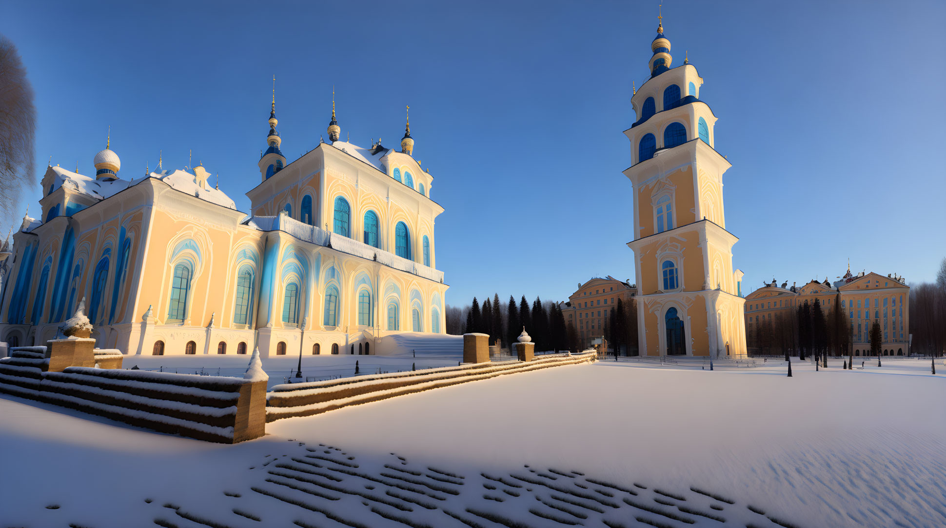 Grand pale blue and yellow church with ornate domes in snowy landscape