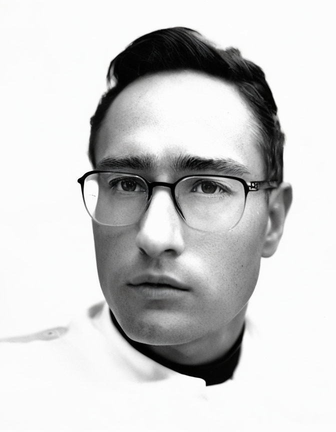 Monochrome portrait of man with glasses and collared shirt