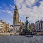 Ornate town square with festive tree and towering spire