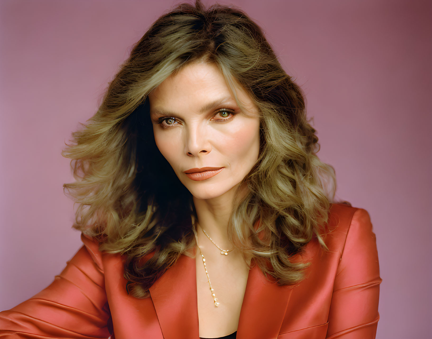 Woman with Voluminous Wavy Hair in Red Jacket on Purple Background