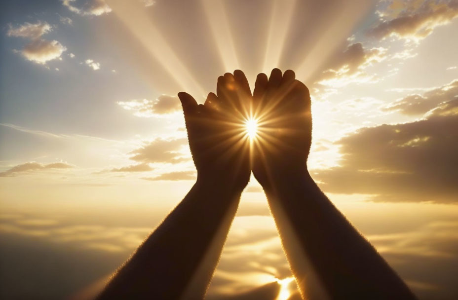 Hands forming heart around sun against cloudy sky at sunrise/sunset