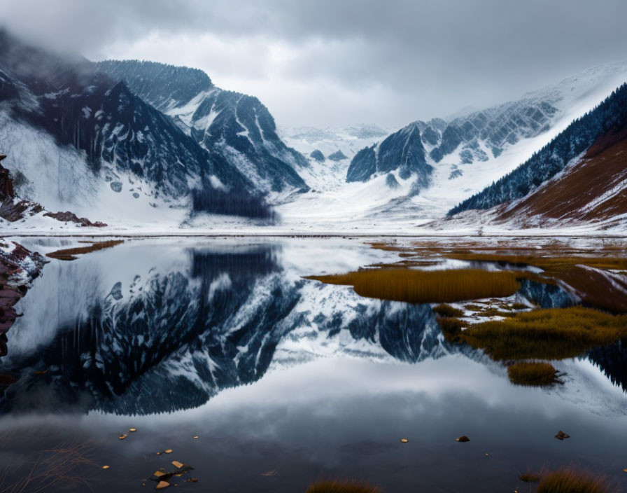 Snow-capped mountains and lake in serene winter landscape