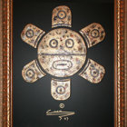 Tribal-style decorative shield with concentric circles and geometric patterns