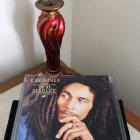 Bob Marley portrait CD case and poster with dreadlocks and red jacket