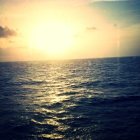 Scenic sunset over ocean with golden light and clouds