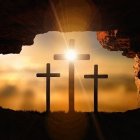 Silhouetted crosses at sunrise in cave opening