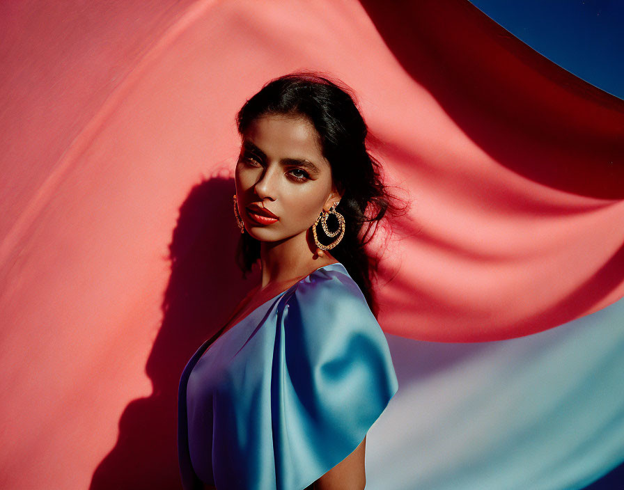 Striking makeup woman poses against red and blue background