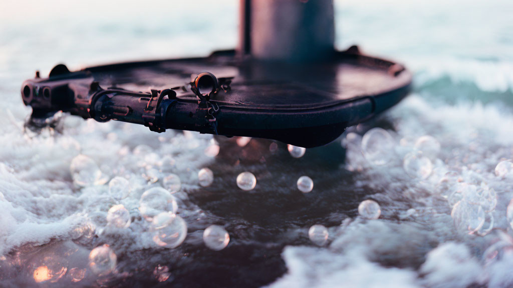 Violin submerged in beach water with waves and bubbles - serene scene