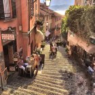 Charming cobblestone street with pink buildings and green shutters