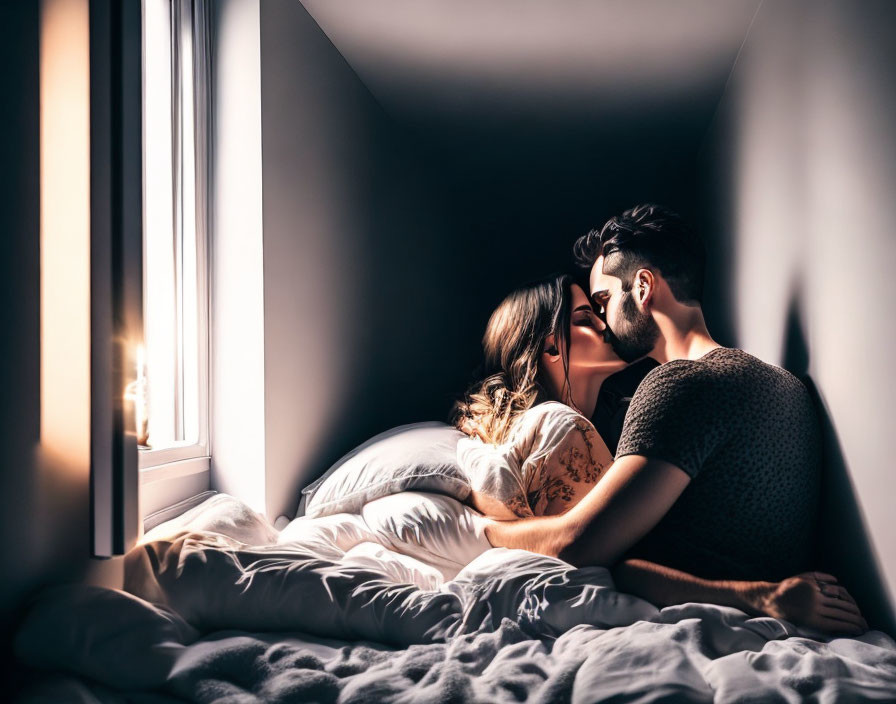 Couple Embraces Tenderly on Bed by Sunlit Window