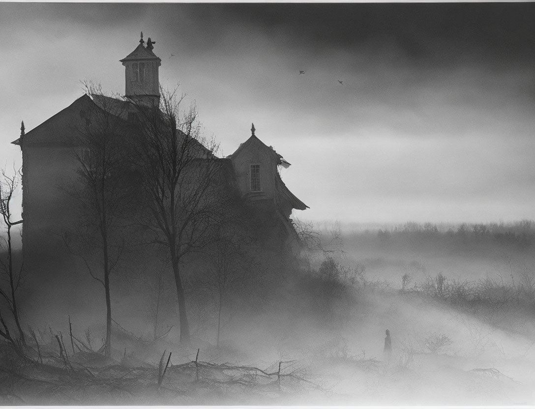 Monochromatic image of figure in foggy landscape with bare trees & ominous house.