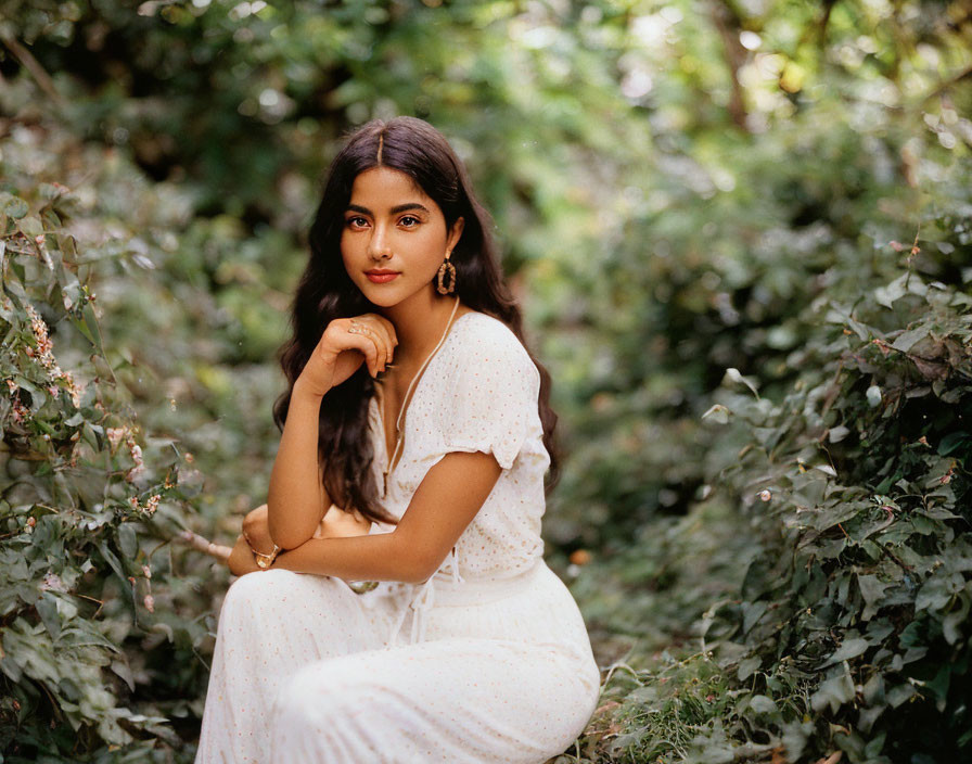 Woman in White Dress Contemplating Among Green Foliage