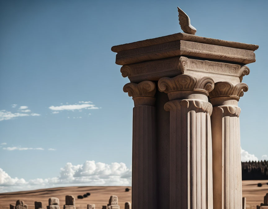 Ornate classical columns with bird against blue sky