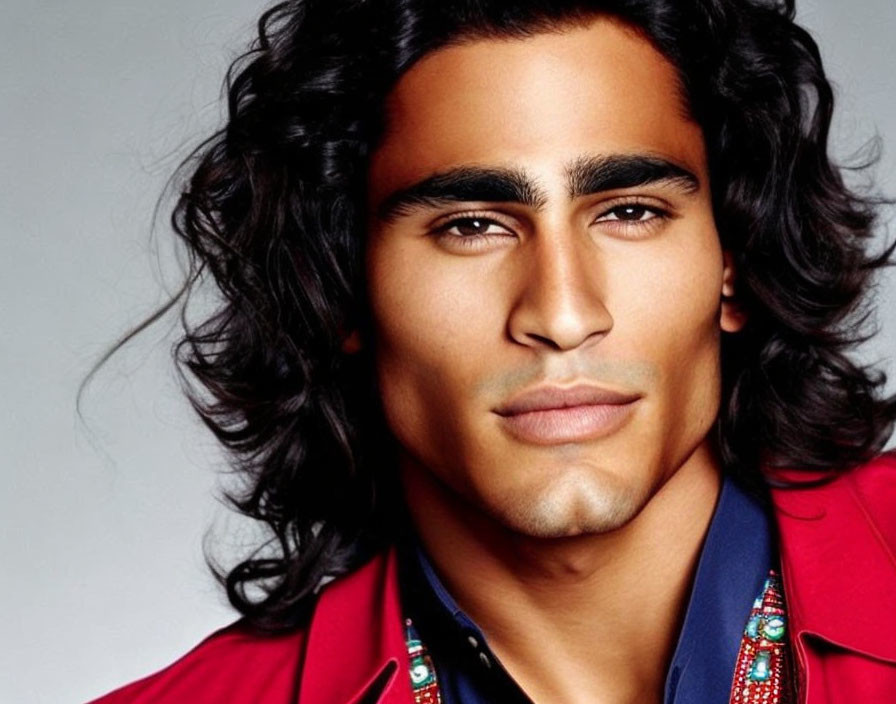 Man with Shoulder-Length Curly Hair in Red Jacket