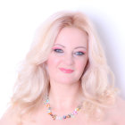 Blonde woman portrait with pearl jewelry and pink outfit