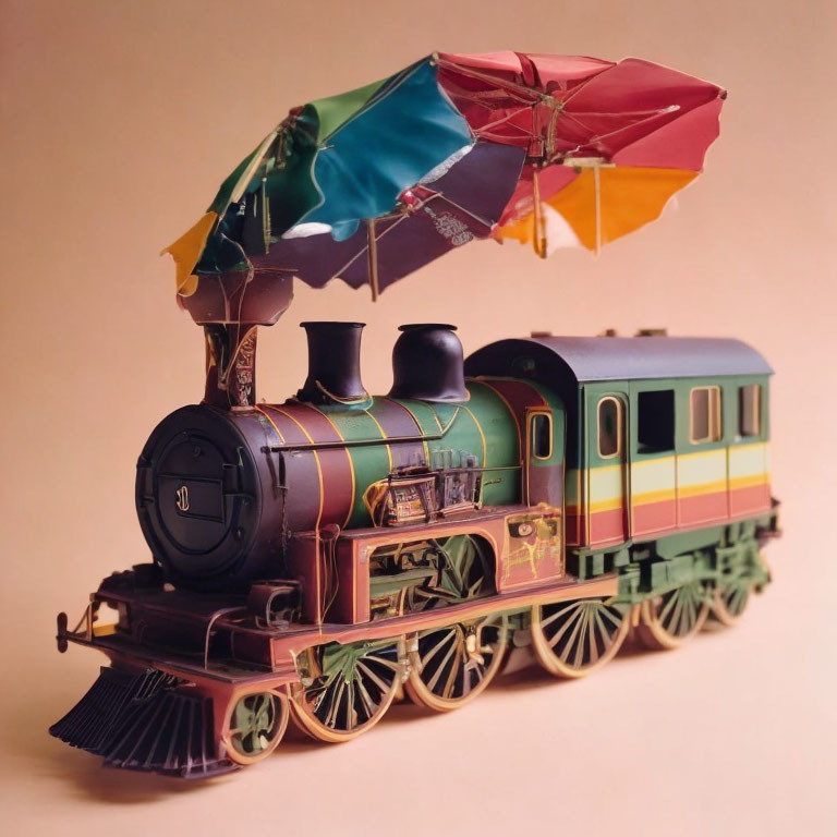 Colorful vintage toy train with multicolored umbrella on top against plain background