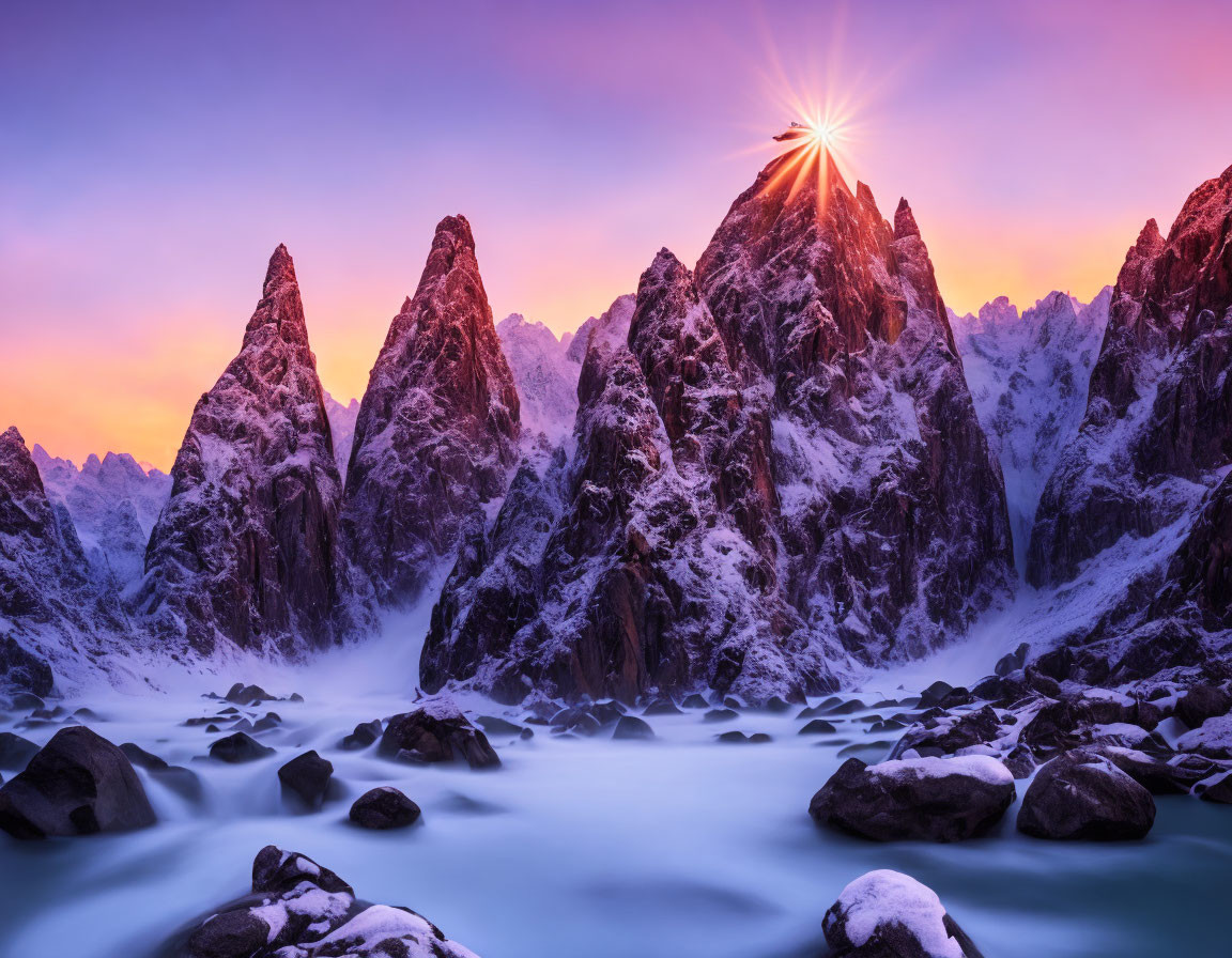 Snowy mountain range at twilight with flowing river and starburst sun.