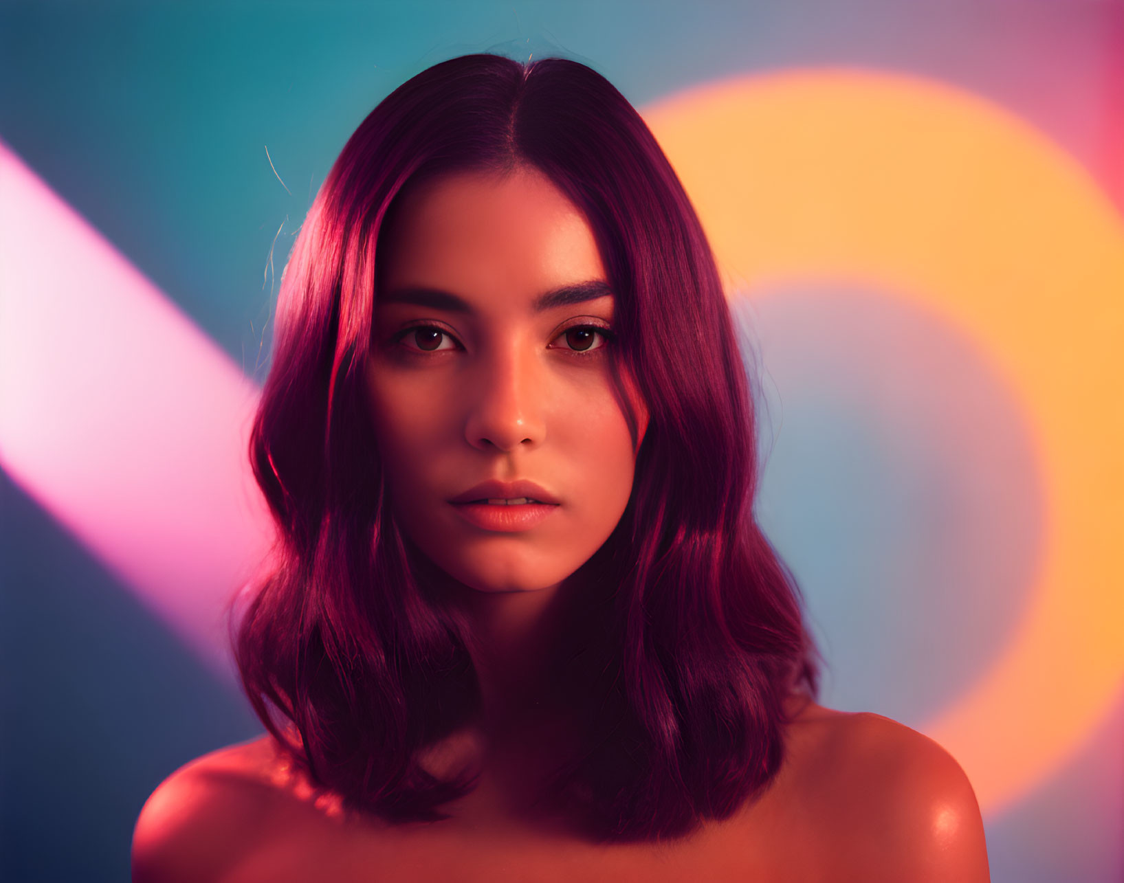 Woman with Shoulder-Length Hair in Vibrant Pink, Blue, and Orange Background