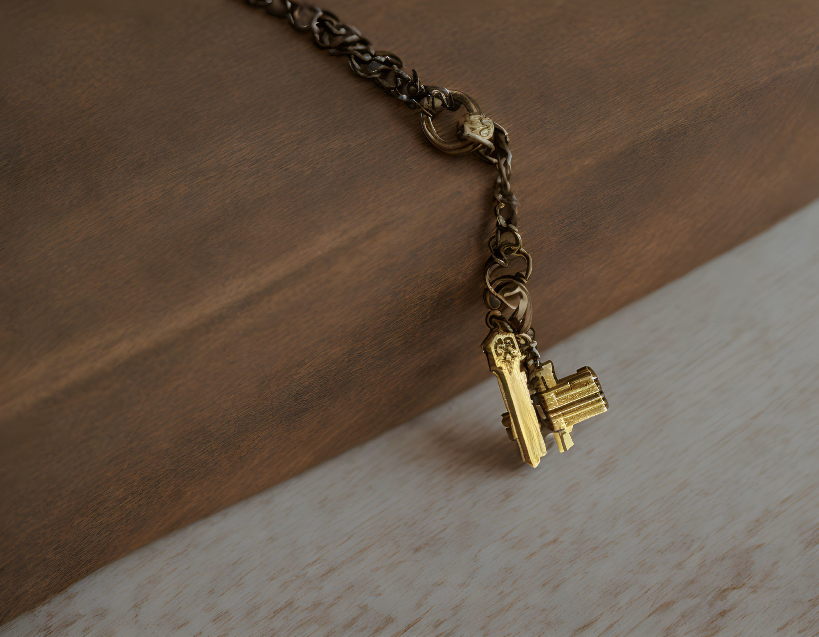 Golden Key Pendant on Chain Resting on Wooden Surface