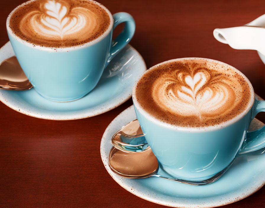 Cappuccino Cups with Heart Latte Art on Wooden Table