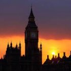 London skyline silhouette at sunset with Big Ben and orange sky