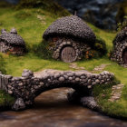 Miniature hobbit-like houses with stone bridge and lush greenery