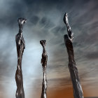 Twisted metallic sculptures in calm water under dramatic sky