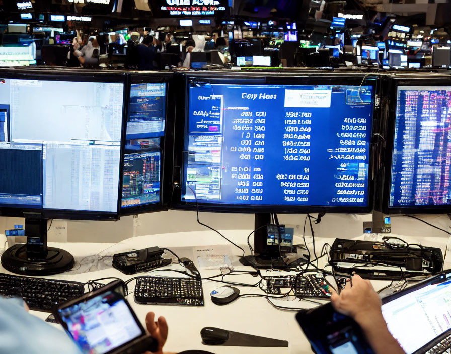 Stock trading floor with traders and monitors showing financial data