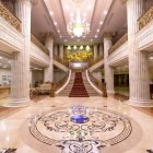 Luxurious Hall with Golden Columns and Grand Chandelier