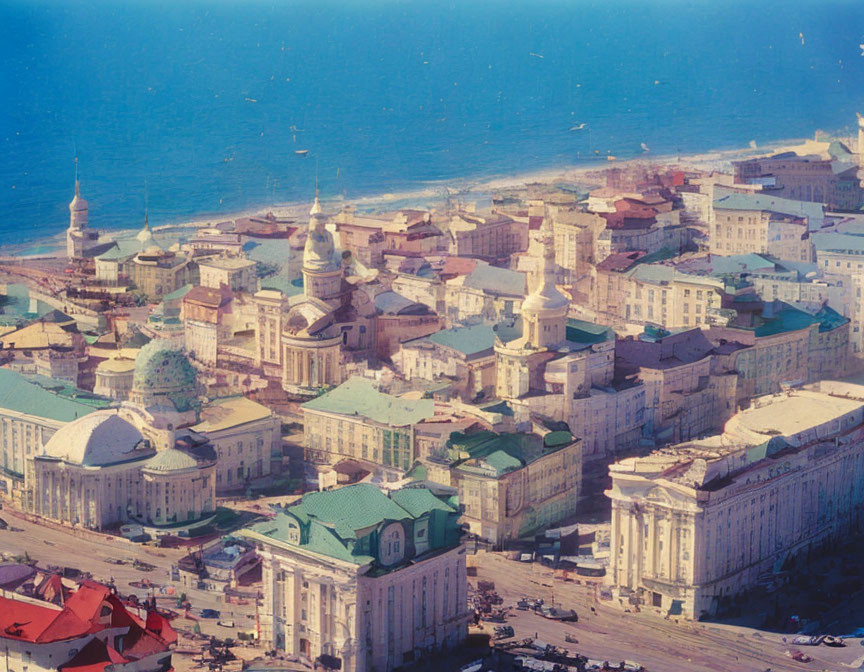 Classical architecture and domed buildings in coastal cityscape.