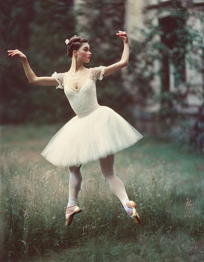 Ballet dancer in white tutu with flower adornments poses gracefully